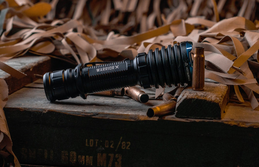 Tactical flashlight on wooden box